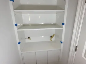 Custom built-in cabinet installation with upper shelving